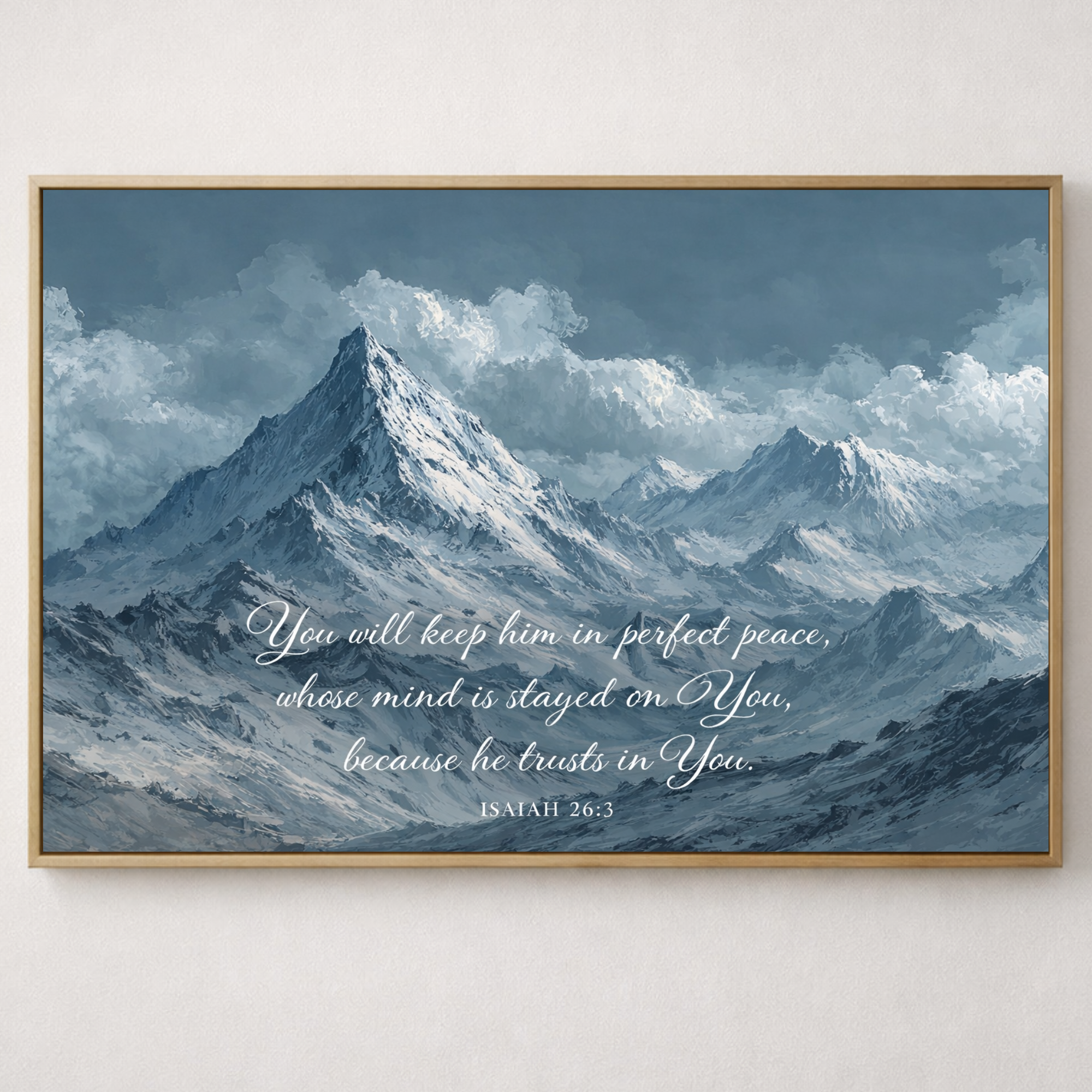 Framed print of a mountain landscape with a biblical quote on a white wall.