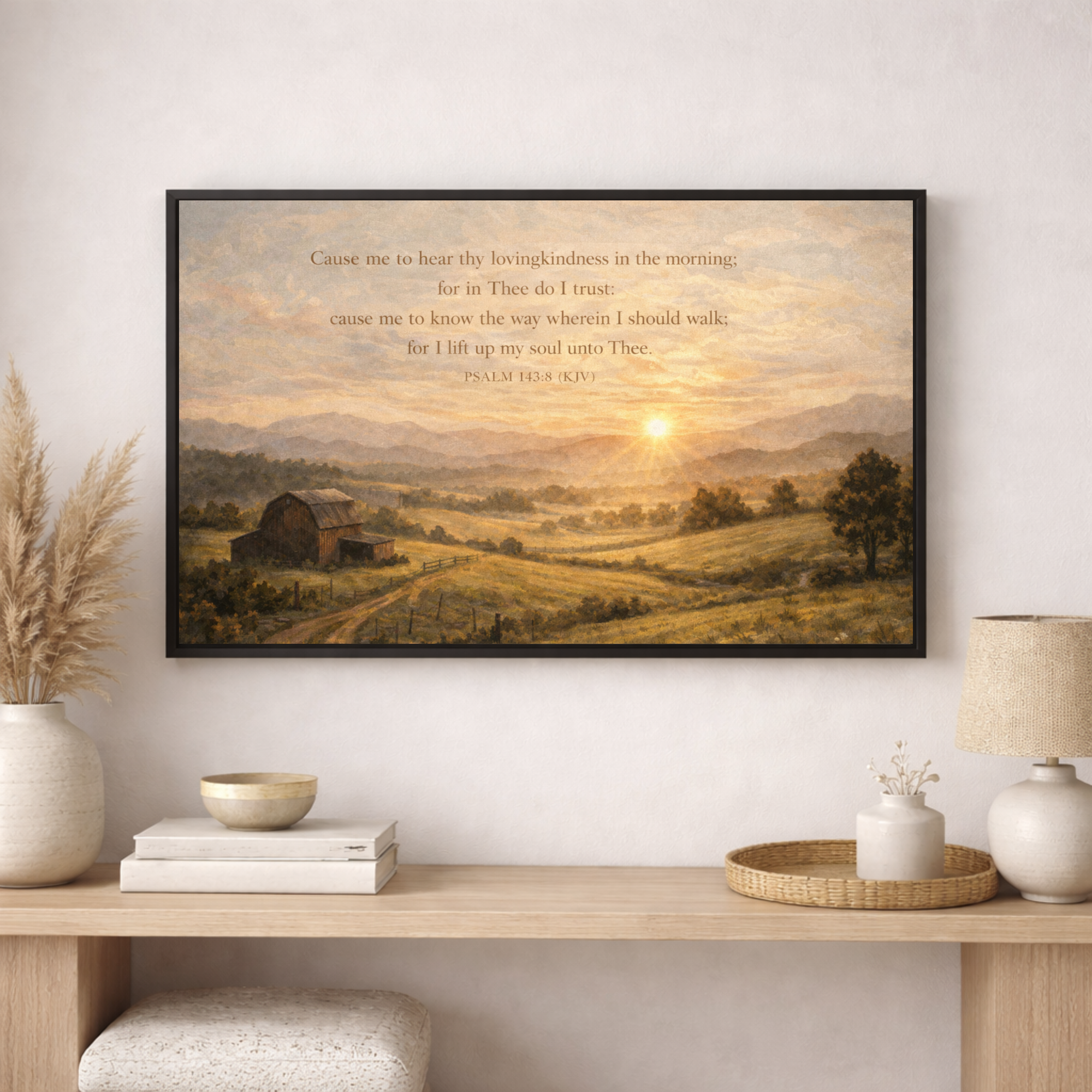 Framed landscape print with a sunset over a field and a barn, displayed on a wall above a wooden console table.