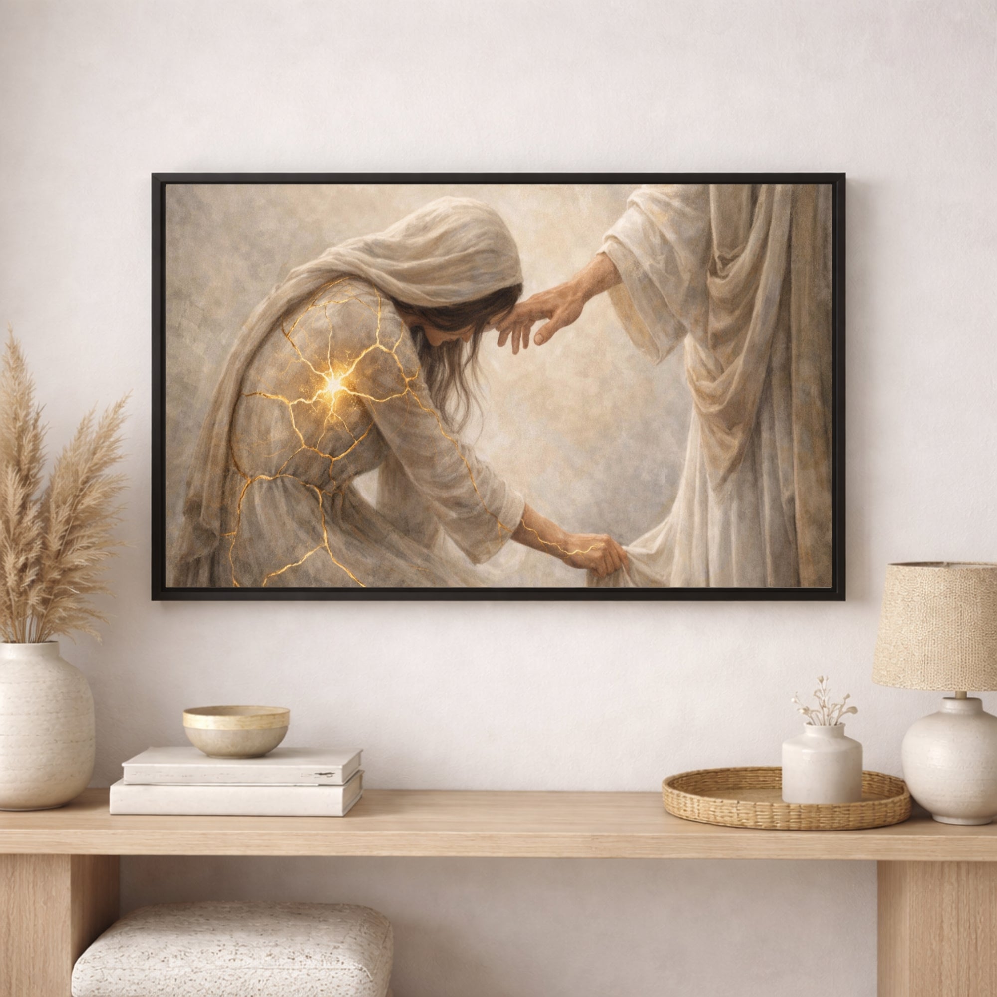Framed artwork of a religious scene on a wall above a wooden console table with decor items.