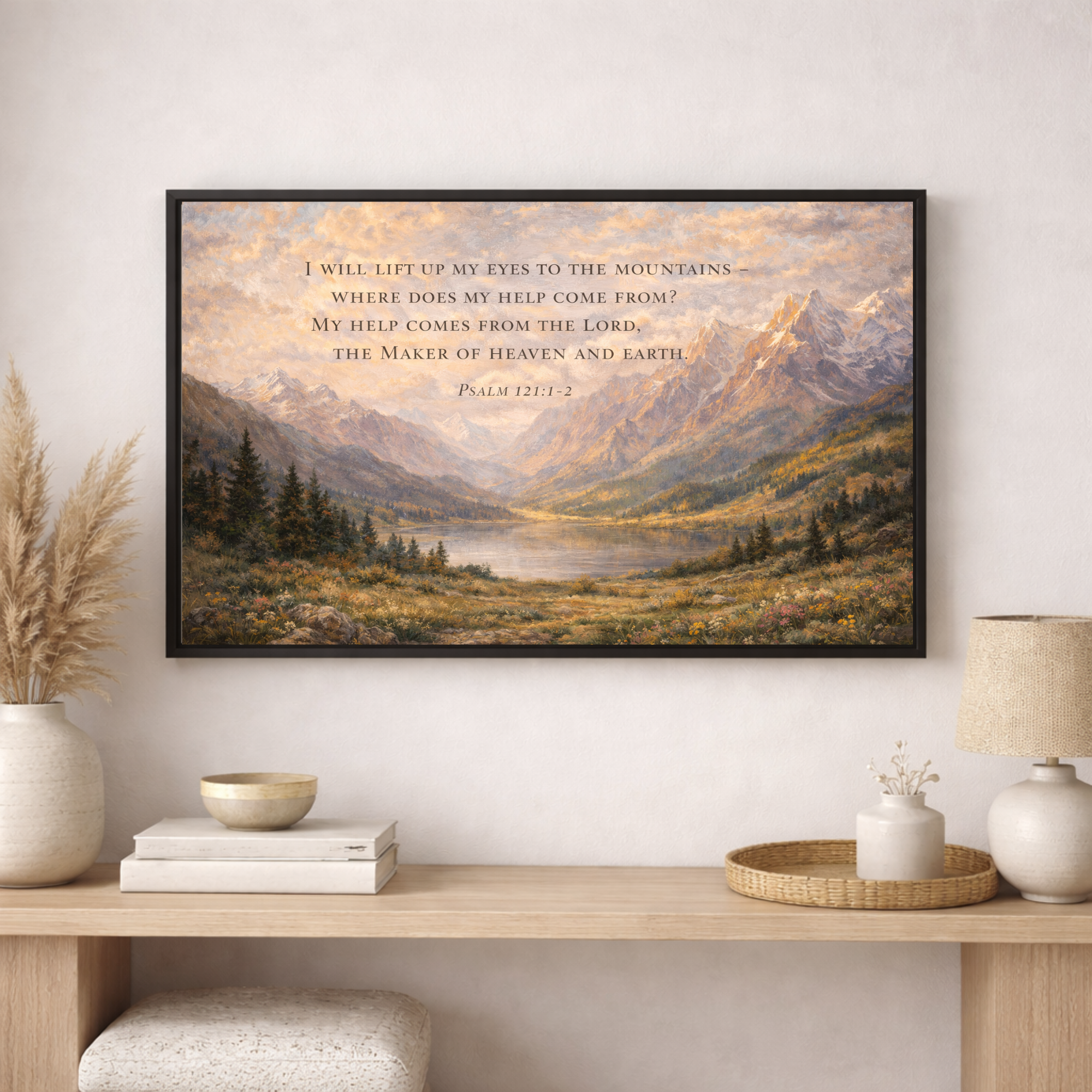 Framed mountain landscape print with scripture on a wall above a wooden console table.