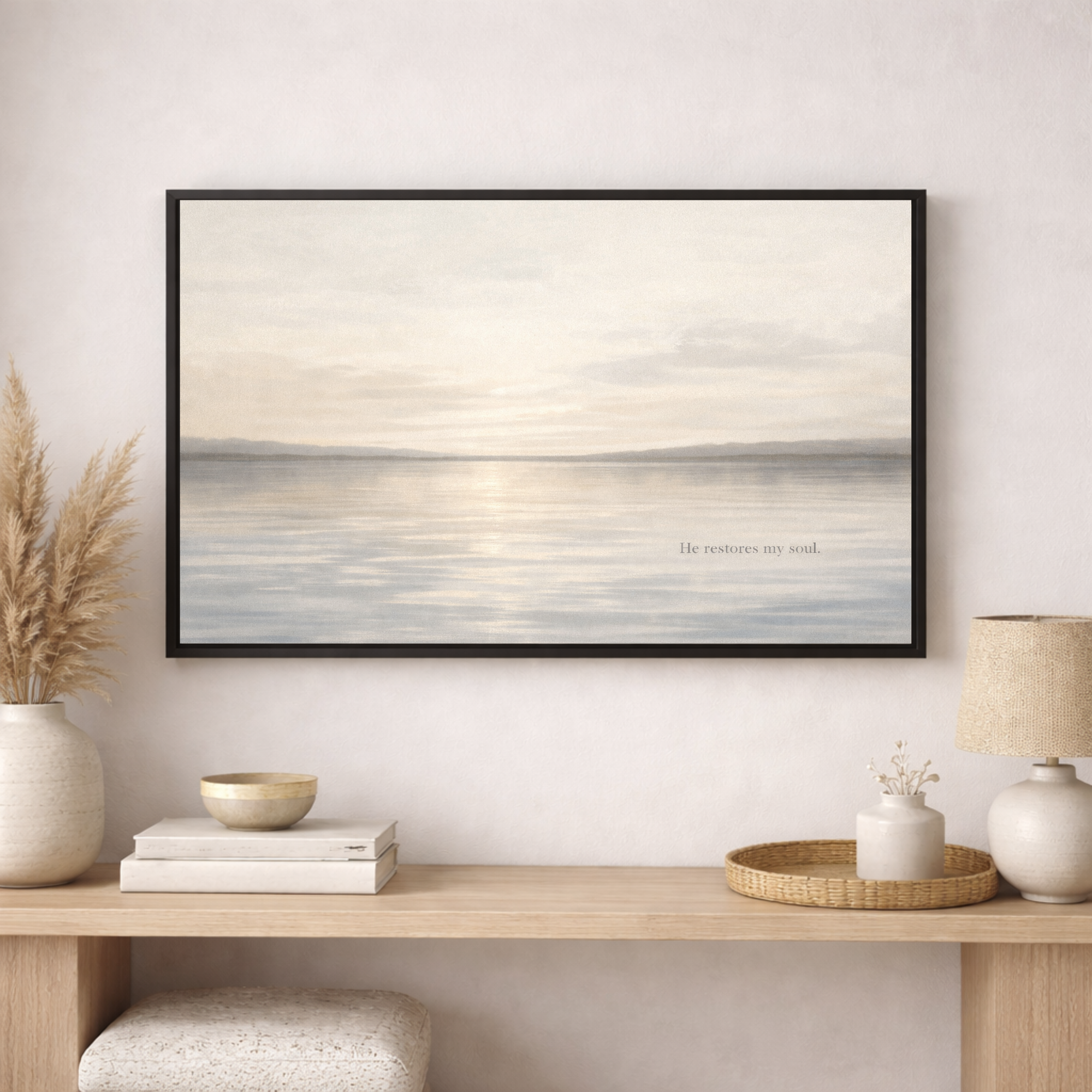 Framed artwork of a seascape on a wall above a wooden console table with decorative items.