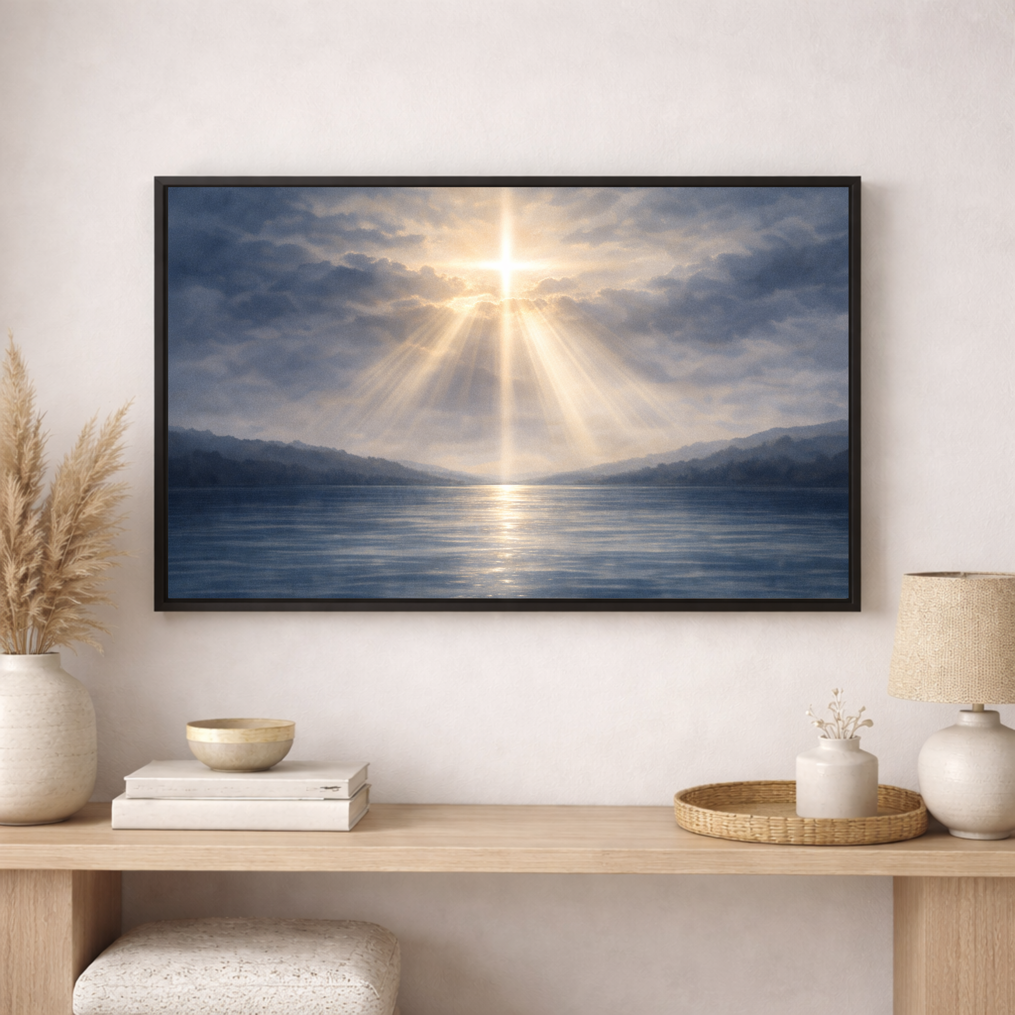 Framed artwork of a sun rising over water with mountains, displayed on a wall above a wooden console table.