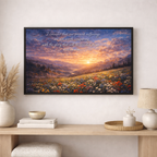 Framed artwork with a sunset over a field of flowers and inspirational quote on a wall above a wooden console table.