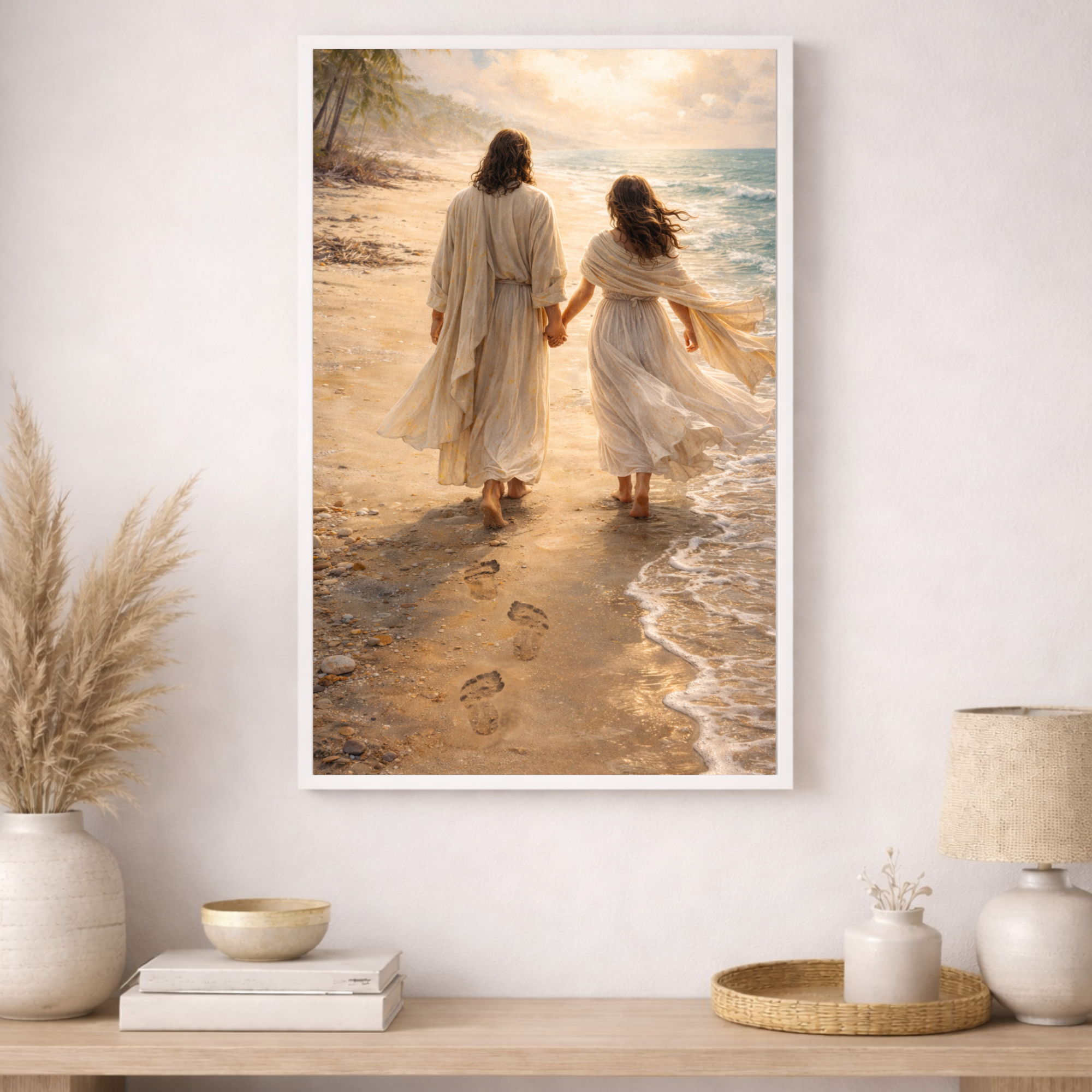 Framed artwork of two people holding hands on a beach, hanging on a wall above a wooden shelf with decorative items.