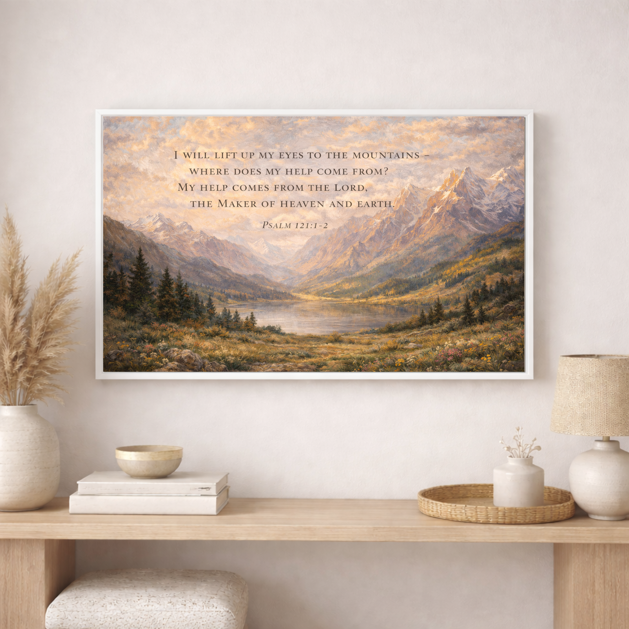 Framed mountain landscape print with scripture on a wall above a wooden console table.
