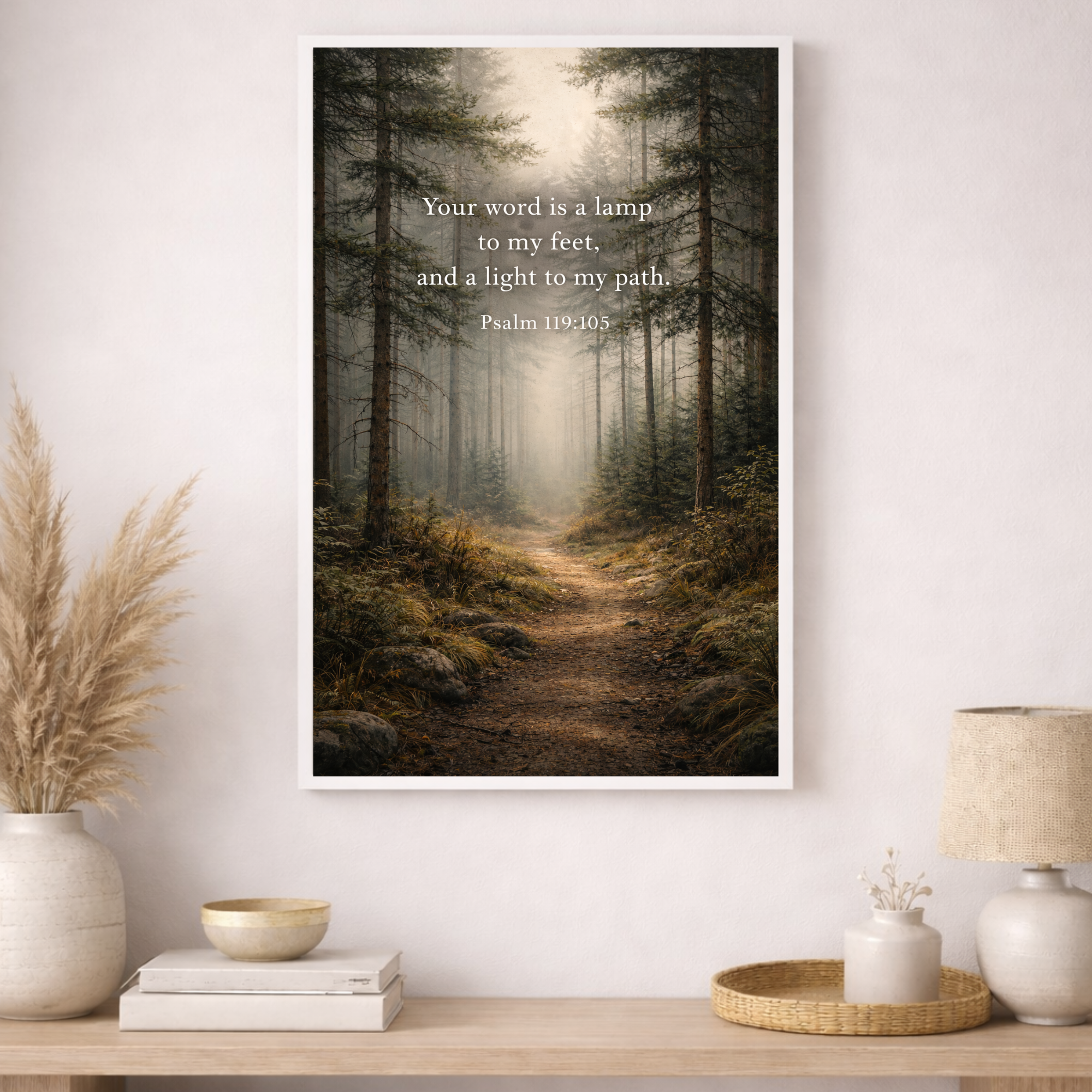 Framed print of a forest scene with a religious quote on a wall above a wooden table.
