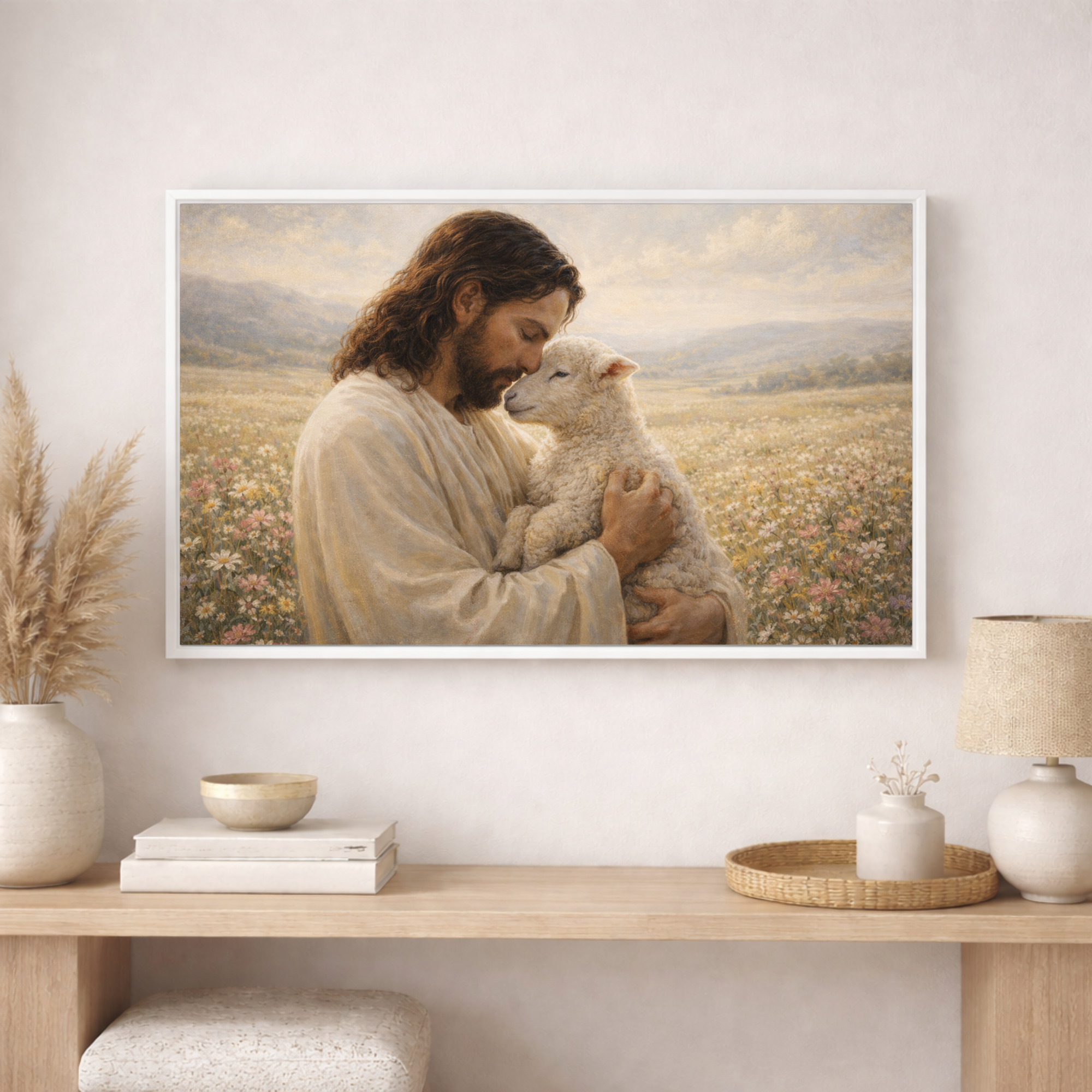 Framed artwork of a man holding a lamb in a field, displayed on a wall above a wooden console table.