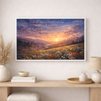 Framed artwork with a sunset over a field of flowers and inspirational quote, displayed on a wall above a wooden console table.