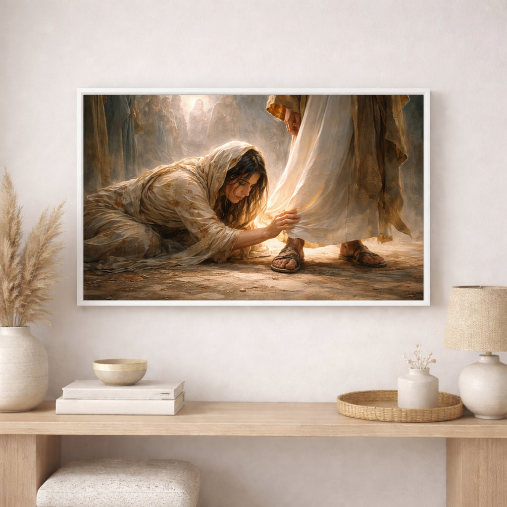 Framed artwork of a woman kneeling and a man reaching out, displayed on a wall above a wooden shelf with decorative items.